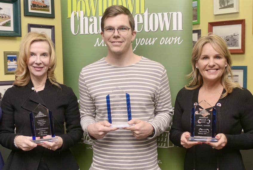 Confederation Centre of the Arts CEO Jessie Inman, left, Cows Inc. VP of production and retail Chad Heron and The Guild’s executive director Alanna Jankov, show the Downtown Charlottetown Inc. Awards they received during the group’s annual general meeting on Tuesday. The awards recognize individuals and businesses who have made exemplary contributions to the vibrancy of the downtown area. MITCH MACDONALD/THE GUARDIAN