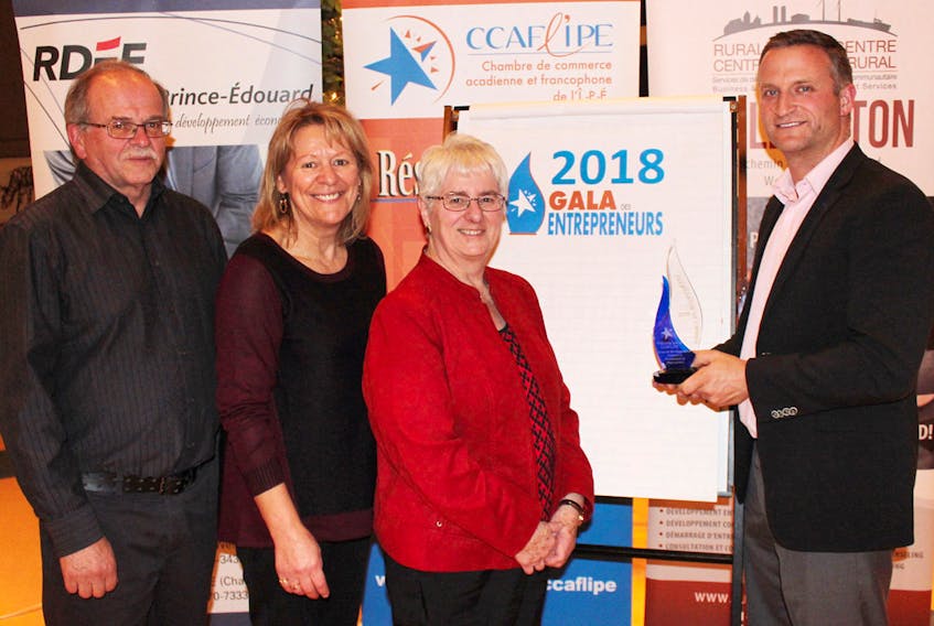 Pierre Gallant, right, spokesperson for the Acadian and Francophone Chamber of Commerce of P.E.I., teases three of the finalists from the Chamber's business award with one of the championship trophies. From left are finalists Alcide Bernard, president of the Agricultural Exhibition and Acadian Festival, Jeannette Gallant, a camp leader with the Centre Goéland - Village des Sources l’Étoile Filante and Jeannette Arsenault, co-owner of the Shop & Play tourist gift shop in Borden-Carleton. SUBMITTED PHOTO
