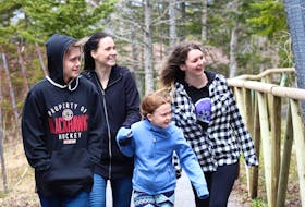 Owen Fletcher, from left, Diane Fletcher, Kendall Fletcher and Ainsley Marshe smile as they pass by the coyote enclosure at Two Rivers Wildlife Park on Wednesday afternoon. The 500-acre site, which features 50 species of native and non-native animals and birds, reopened this past weekend for the first time in several weeks after Nova Scotia eased public health restrictions around COVID-19. Chris Connors/Cape Breton Post