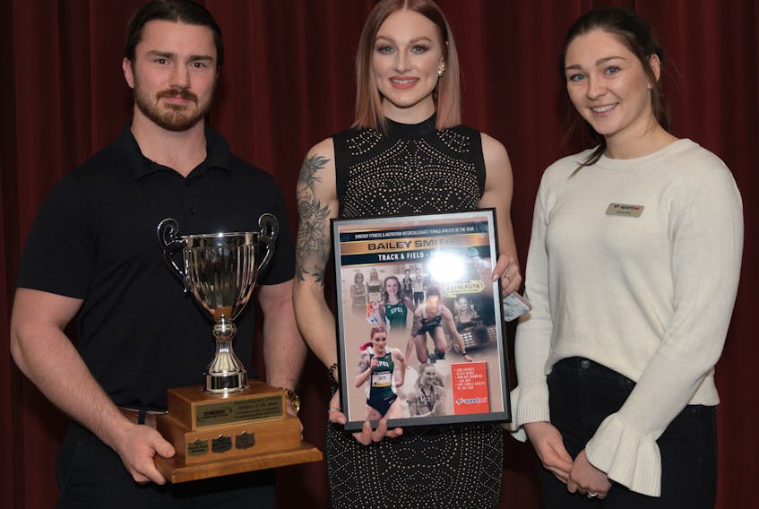 Sprinter Bailey Smith, centre, won the Synergy Fitness & Nutrition intercollegiate female athlete of the year award Wednesday in Charlottetown. Making the presentation was Nick Lund from Synergy and Alexa Ellis, the Prince County director on Sport P.E.I.’s board of directors. Phil Matusiewicz/Special to The Guardian
