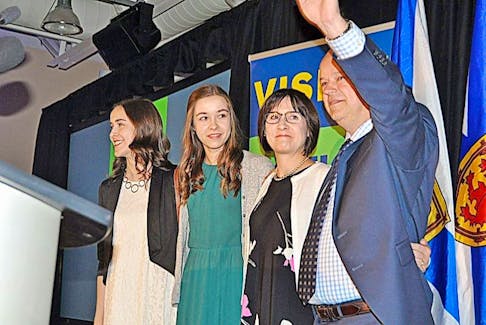 Nova Scotia PC leader and Cumberland South MLA-elect Jamie Baillie waves to the crowd along with his wife Sandra and daughters Hannah and Alex after speaking to supporters late Tuesday.
