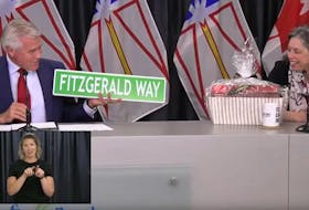Outgoing Premier Dwight Ball presents gifts to Chief Medical Officer of Health Dr. Janice Fitzgerald Wednesday during his last appearance at the weekly COVID-19 briefings in St. John's. Inset: ASL interpreter Heather Crane. Image from video