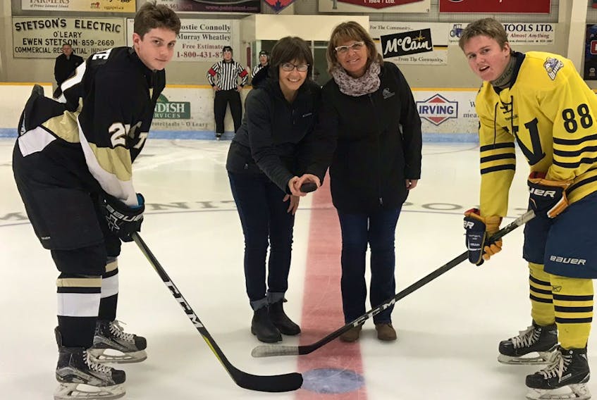 The visiting Central Attack and Prince County Warriors opened the 2018-19 P.E.I. Major Bantam AAA Hockey League regular season at the O’Leary Community Sports Centre on Sunday afternoon. Della Sweet, second left, of O’Leary Minor Hockey and league co-ordinator Sandra Jamieson drop the puck for the opening faceoff between Attack captain Kal White, left, and Prince County captain Cody McCormack. The Attack won the game 6-0.