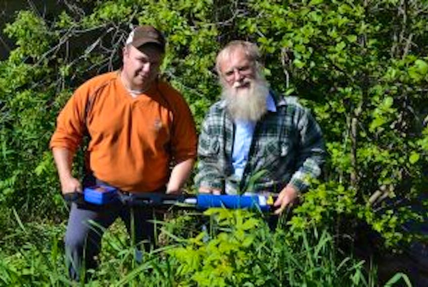 ['<p>Probing Barclay Brook for answers</p>\n<p>Morgan Smallman, left and environmental scientist John Purdy explain the features of in-stream probes that will be recording numerous water quality factors in the Barclay Brook and the Little Pierre Jacques River in West Prince this summer. A study funded by CropLife Canada is trying to determine what has been causing fish deaths in the Barclay Brook in recent years.</p>']