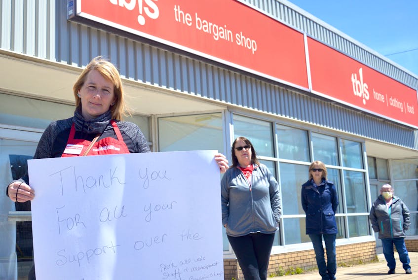 Tracy MacLeod, left, holds a sign thanking customers for their support over the years at the New Waterford Bargain Shop. The New Waterford location will not be reopening as originally planned. From left are MacLeod (17 years of service), Karen MacDonald (18 years of service), Janice Desveaux (26 years of service) and Cassie Harper (14 years of service). JEREMY FRASER/CAPE BRETON POST