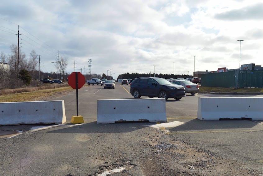 Traffic moves between Towers Road and the Cineplex parking lot at the Charlottetown Mall recently. Killam Apartment REIT and the City of Charlottetown have set up concrete barriers blocking motorists from using a temporary road to Spencer Drive until repairs can be made in the spring.