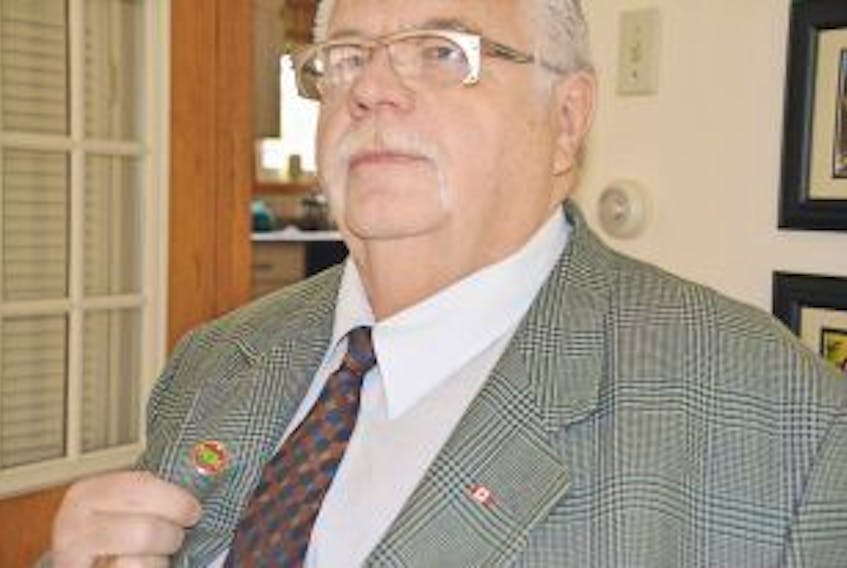 ['Former Summerside mayor Basil Stewarts shows off his Federation of Canadian Municipalities pin. Stewart, who also served as FCM president, is being inducted into the organization’s Hall of Honour, the first Summerside mayor to receive the honour. <br />']
