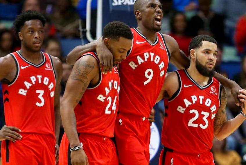 Toronto Raptors forward Serge Ibaka is helped off the court by guards Norman Powell and Fred VanVleet in the second quarter against the New Orleans Pelicans at the Smoothie King Center. 