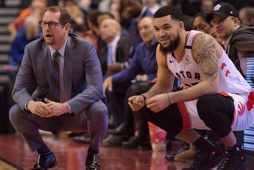 Toronto Raptors head coach Nick Nurse and guard Fred VanVleet (23) watch play against Chicago Bulls in the first half at Scotiabank Arena. 