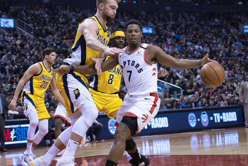 Toronto Raptors guard Kyle Lowry controls a ball as Indiana Pacers forward Domantas Sabonis defends during the second quarter at Scotiabank Arena. 