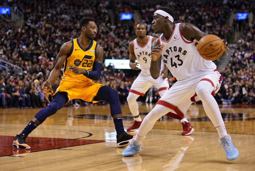 Toronto Raptors forward Pascal Siakam looks to make a play against Utah Jazz forward Jeff Green during the first half at Scotiabank Arena. 