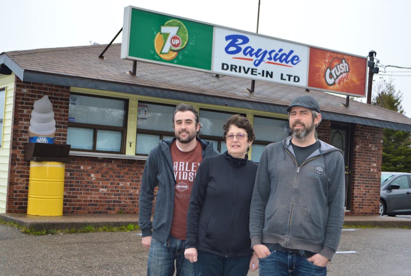 Elizabeth Musial, owner of the Bayside Drive-In in Gardiner Mines, with sons Bradley Musial, left, and Marc Musial. The 60-year-old business opened for the season on Saturday, but after less than two days they had to close because they ran out of food. They reopened on Tuesday. Sharon Montgomery-Dupe/Cape Breton Post