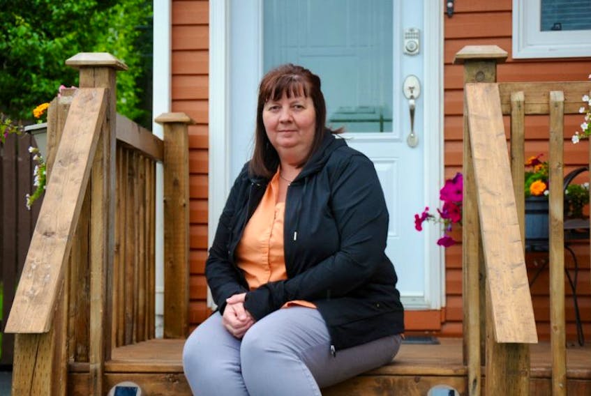 Joanne Head, secretary for the Lakeview Courts steering committee, sits on the steps of her mobile home. She’s been a part of an effort to purchase the land her home sits on from Killam Properties Inc.