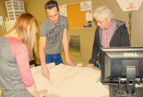 Gander Heritage researchers, pictured from the left, Natasha Pearce, Paddy Penney and Dan Kelly, review an airport map.