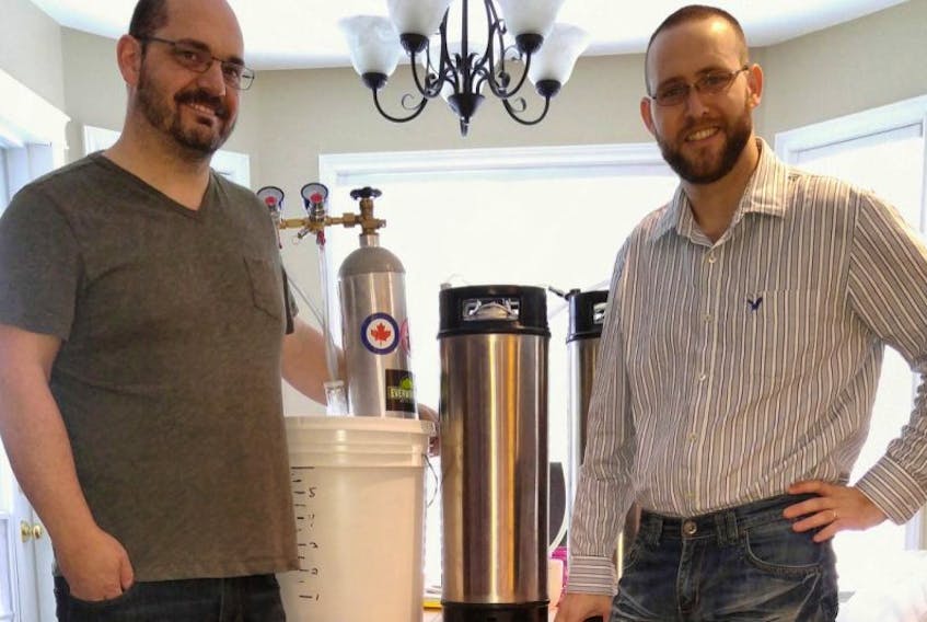 Dave Jerrett, left, and Sam Newman ready a batch of their latest craft beer. Their aim is to open Scudrunner Brewing Limited in Gander.