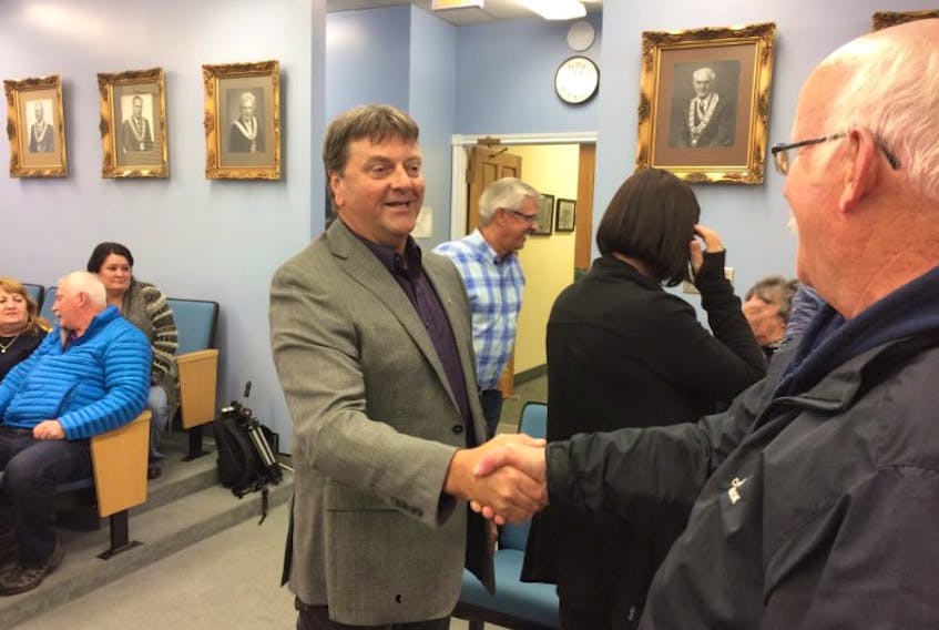 Percy Farwell is met with congratulations as he enters Gander town hall as mayor-elect.