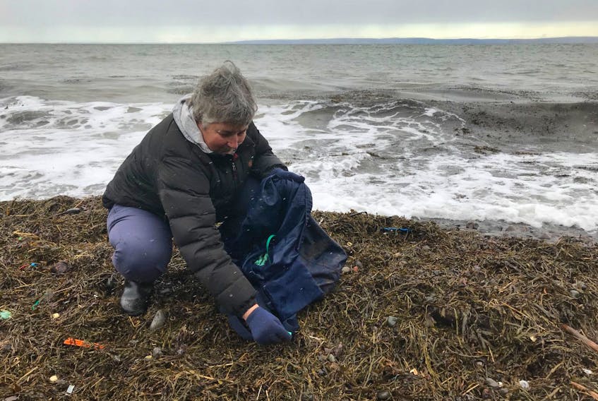 Karen Jenner picks up garbage at the beach in Black Rock, Kings County. She has collected 14,000 pounds of garbage in the past two and a half years since deciding to try to do something about the amount of plastics and other items on the local beaches along the Bay of Fundy.