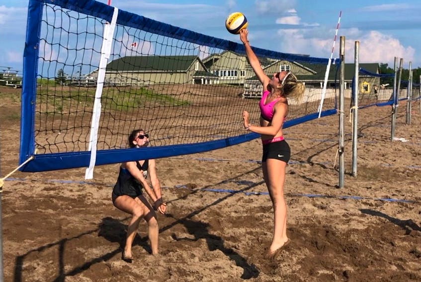 Monica Gollaher tips the ball over the net while Seven McHatten awaits the ball. Gollaher and Marie Fogarty pulled out a three-set victory over McHatten and Ella Hickey in an all-Red Rock Volleyball Club final in the under-16 category at the recent Atlantic Beach Tour stop at Parlee Beach in Shediac, N.B.