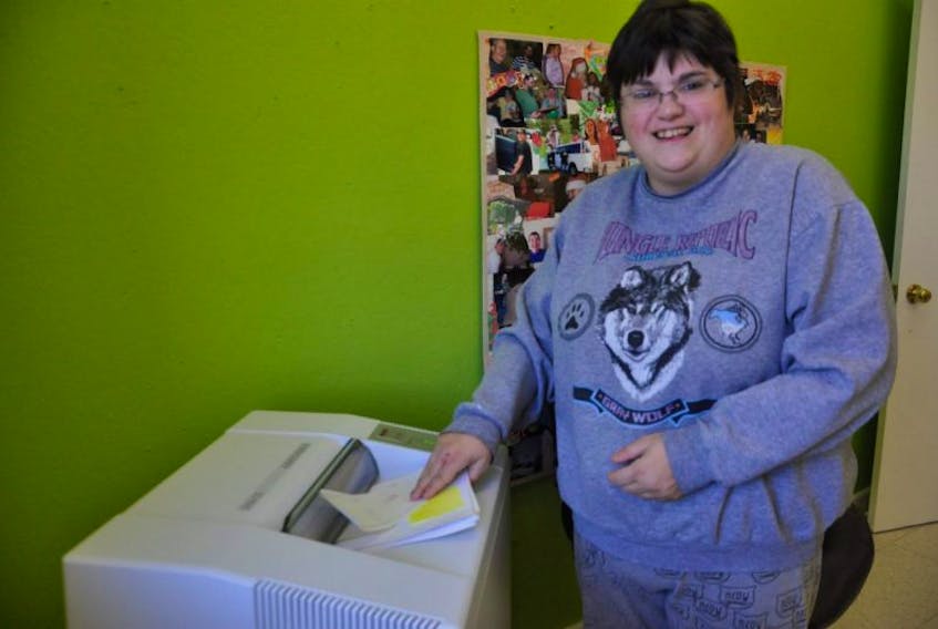 <p>Robynn Wilson shows off the new paper shredding equipment at the Beehive Adult Service Centre in Aylesford.</p>