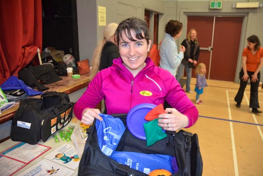 Department of Health and Wellness regional physical activity coordinator Anna Sherwood shows some of the items aimed at promoting physical literacy found in the ‘Be Fit Kit’.