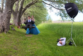 Photographer John Ratchford gets low to get the perfect shot of Tori Ranni, 18, pushing Adam Steylen, 17, on a swing as the high school grads laugh hard. NICOLE SULLIVAN/CAPE BRETON POST