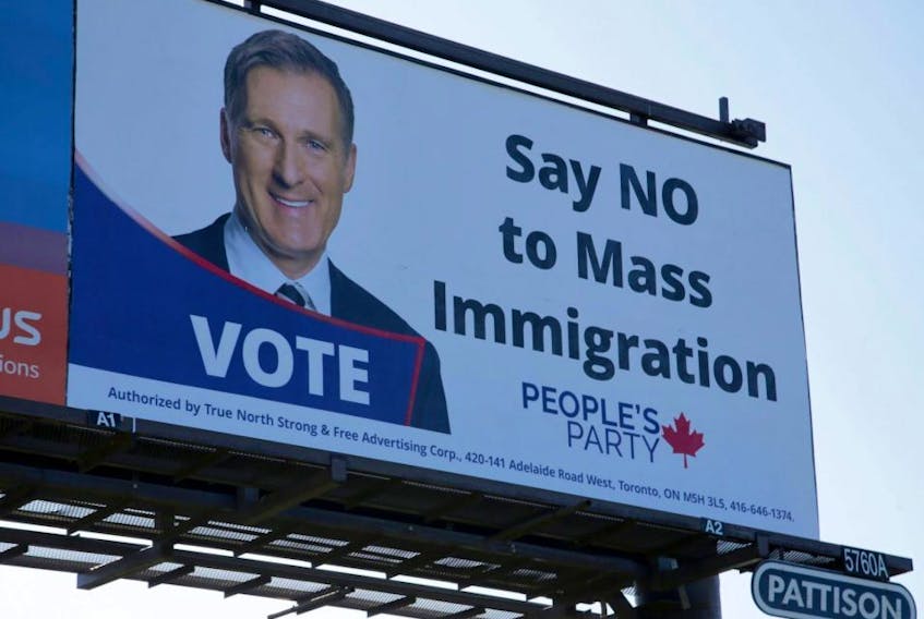 A billboard featuring the portrait of People’s Party of Canada leader Maxime Bernier and its message "Say NO to Mass Immigration" is displayed in Toronto on Sunday, Aug. 25, 2019.