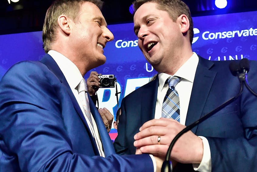 Maxime Bernier, left, congratulates Andrew Scheer on winning the federal Conservative leadership, May 27, 2017.