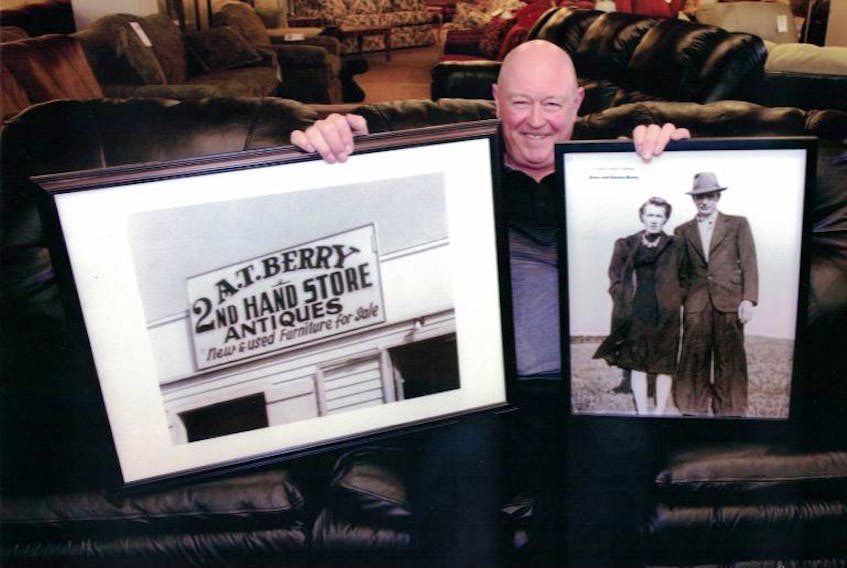 Don Berry holding pictures of the original Berry’s Furniture location and his parents, Alex and Emma Berry.