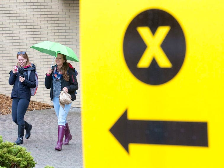 University of Ottawa students Freyja Wilson (L) and Sophie Pellerin leave St. Paul University after voting at an advance poll Oct. 9, 2015 for the Oct. 19, 2015 federal election.