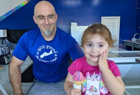 Sean MacDonald and his "boss," youngest daughter and three-year-old Sylvia. The ice cream shop owner has moved the business out of his home, but the family continues to be actively invovled.