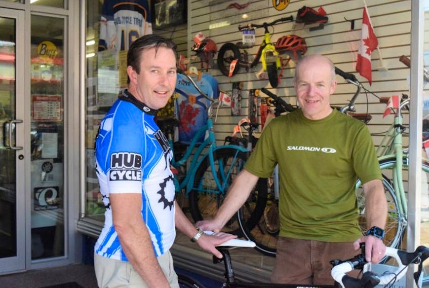 <p>Dr. Steve Ellis, left, talks with Bruce Roberts of Hub Cycle in preparation for Give to Live’s Big Ride. For the second year, Ellis is participating in the ride with teammates and they’ll each bicycle 200 kilometres on the Cabot Trail on July 17. Money being raised will go to the Canadian Cancer Society’s The Lodge That Gives.</p>
