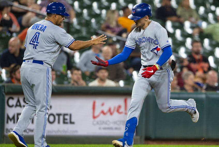 Toronto Blue Jays second baseman Cavan Biggio, right, celebrates with  third base coach Luis Rivera after hitting a two run home run during the third inning against the Baltimore Orioles at Oriole Park at Camden Yards, Sept. 17, 2019. (Tommy Gilligan-USA TODAY Sports)