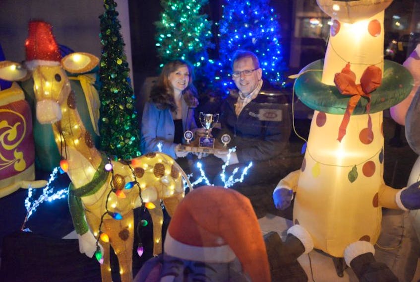 <span>Charlottetown architect Bill Chandler has won his fifth Downtown Christmas Window Display competition for his display in the Campbell Lea building on Queen Street in Charlottetown. Presenting Chandler with his award is Dawn Alan, executive director of Downtown Charlottetown Inc. </span>