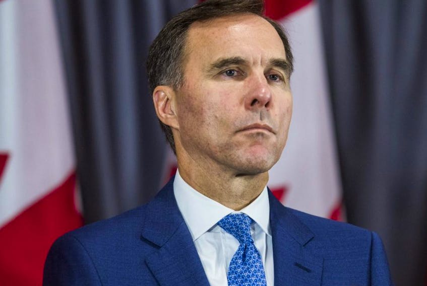 Federal Liberal incumbent candidate Bill Morneau listens during an announcement by federal Liberal leader Justin Trudeau at a campaign event in Toronto on Sept. 20, 2019.