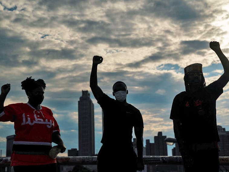 People raise their fists in Atlanta at an event to mark Juneteenth, which commemorates the end of slavery in Texas, two years after the 1863 Emancipation Proclamation freed slaves elsewhere in the United States.