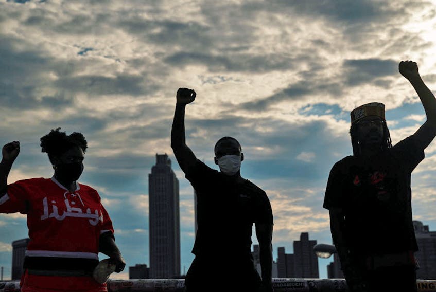 People raise their fists in Atlanta at an event to mark Juneteenth, which commemorates the end of slavery in Texas, two years after the 1863 Emancipation Proclamation freed slaves elsewhere in the United States.