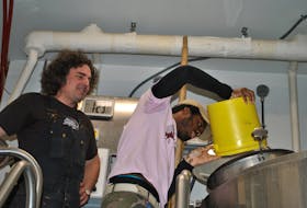 Boxing Rock co-founder and brewer Henry Pedro watches as O’Neil Miller pours the hops in the Back to Birchtown brew. O’Neil is also a fonder of the Change Is Brewing Collective. KATHY JOHNSON/TRI-COUNTY VANGUARD