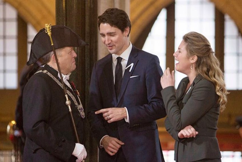 Prime Minister Justin Trudeau and Sophie Gregoire-Trudeau speaks with the Usher of the Black Rod Greg Peters, a former Prince Edward Islander, as they wait for the arrival of the Governor General David Johnston for the speech from the throne in the Senate Chamber on Parliament Hill in Ottawa, Friday December 4, 2015.