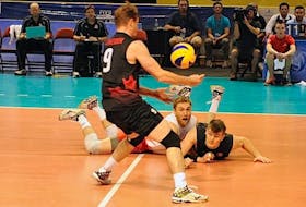 Canada’s Blair Bann, second from left, and Gordon Perrin dove to keep this ball alive for Dustin Schneider during the opening set of a Federation International Volleyball (FIVB) World League match versus Bulgaria at Eastlink Arena in Summerside on Friday night.