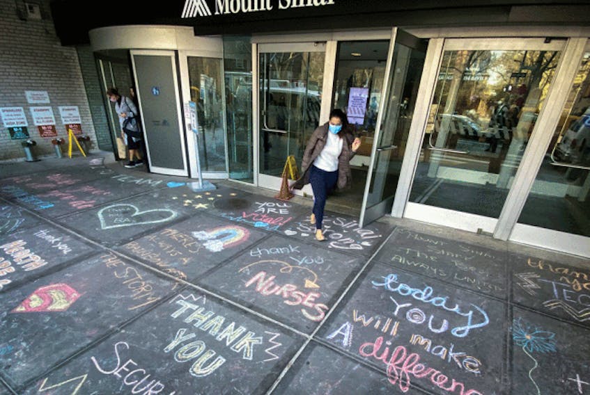  Messages of thanks are written on the sidewalk outside Mount Sinai Hospital in Manhattan during the COVID-19 outbreak.