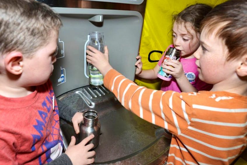 <p>Colby Britton, left, Summer Britton, and Levi White fill their water bottles from a public fountain at Holland College recently. The Council of Canadians is urging the City of Charlottetown to do more to preserve water.</p>