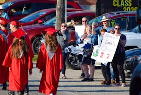 The BMHS Class of 2020 is cheered on by well-wishers as they parade through the Barrington Passage business district on June 21. Kathy Johnson