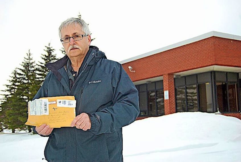 Stephenville businessman Bob Byrnes holds the envelope that took 41 days to come from Washington, D.C., to Stephenville.