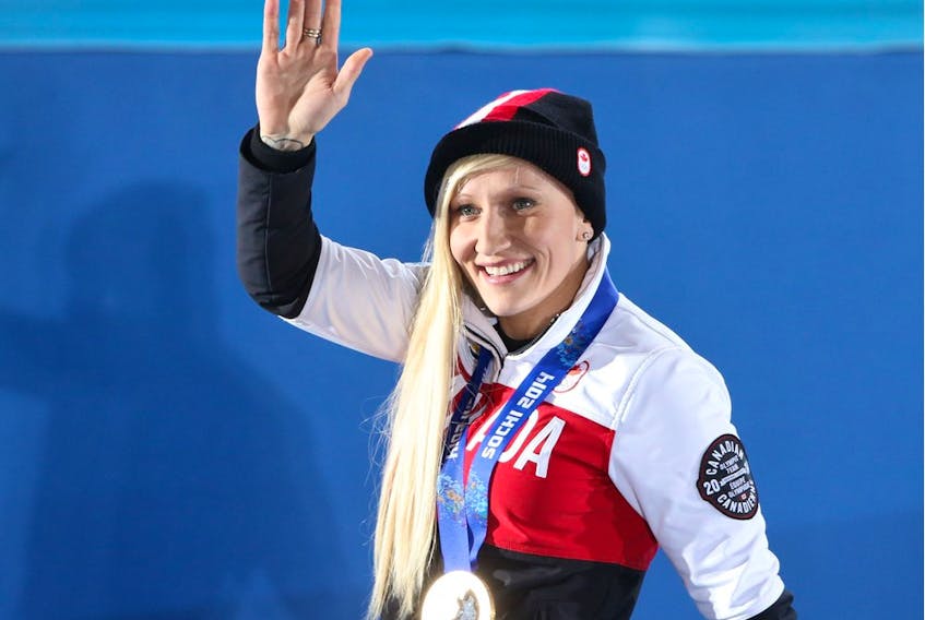 Gold medalist Kaillie Humphries waves to the crowd during the women's bobsleigh medal ceremony at the Sochi 2014 Winter Olympics.