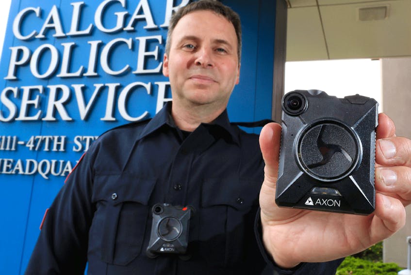 Calgary Police Service Staff Sgt. Travis Baker shows the service's new Axon body camera on July 3, 2018. Calgary's police force is one of the few in Canada to use the technology.