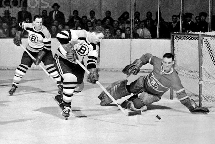 The Montreal Canadiens’ Jacques Plante dives to make a stop on the Boston Bruins’ Vic Stasiuk as Cal Gardner follows the play in this file photo from a Dec. 14, 1955 game at Boston Garden. Five months later, with the Bruins one of two original six teams outside the playoff picture, the team was brought to Newfoundland by Gerry Regan, future Nova Scotia premier and federal cabinet minister, to tour the island and take on local hockey teams in seven games over 10 days.