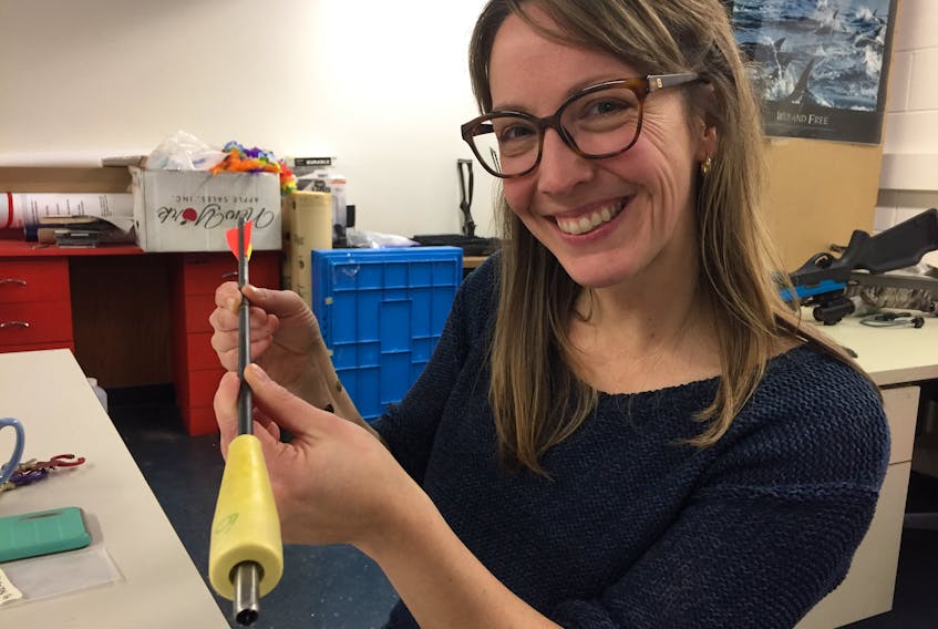 PhD candidate Laura Feyrer holds a biopsy dart that she uses to gather DNA material from northern bottlenose whales off Nova Scotia. - John McPhee