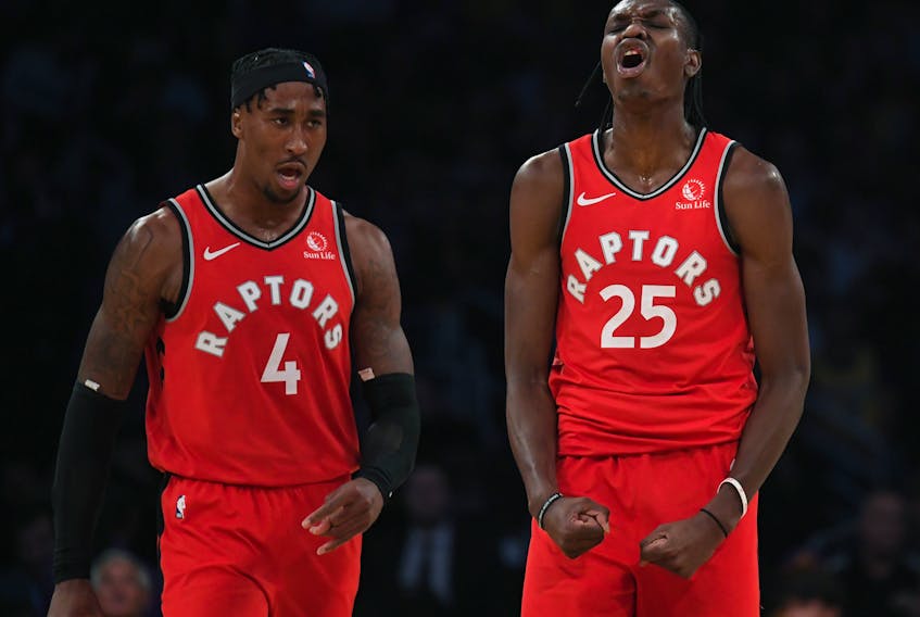 Raptors’ Rondae Hollis-Jefferson (left) and Chris Boucher celebrate during Toronto’s win over the Lakers in Los Angeles on Sunday. Both players have been solid for the Raps, who are currently without several key players due to injuries. (GETTY IMAGES)