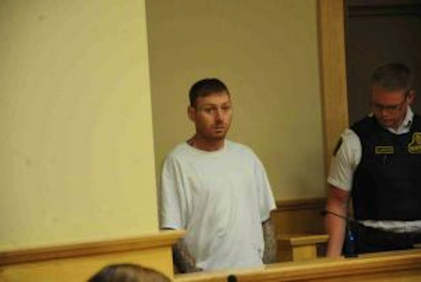 ['Trevor Francis Bourgeois is seen during a brief appearance in provincial court in Corner Brook on charges of armed robbery and possession of a weapon dangerous to the public Monday, Aug. 1.']