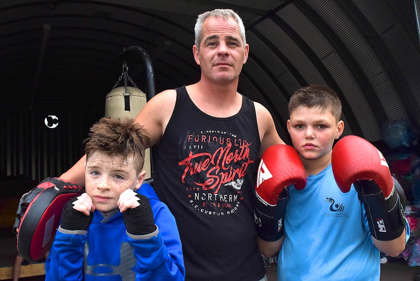 Westville Boxing Club head coach Aaron Kinch is shown with Bohan Pettipas, left, and Hunter Naugle.